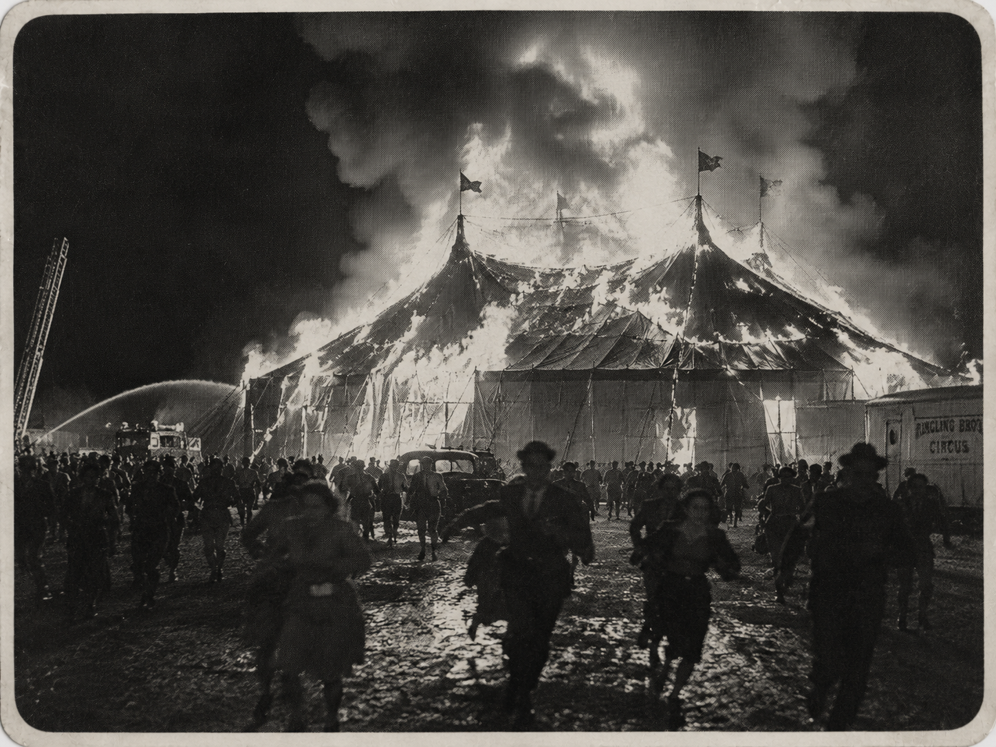 Archival newspaper photograph of a circus tent burning at night while a crowd flees.